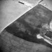 Oblique aerial view centred on the cropmarks of the settlement with settlement adjacent, taken from the ESE.