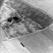 Oblique aerial view centred on the cropmarks of the settlements, taken from the W.