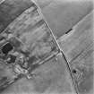 Oblique aerial view centred on the cropmarks of the settlements, taken from the N.