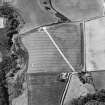 Oblique aerial view centred on the cropmarks of the settlement and possible enclosure, taken from the E.