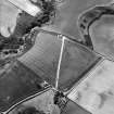 Oblique aerial view centred on the cropmarks of the settlement and possible enclosure, taken from the NE.