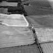 Oblique aerial view centred on the cropmarks of the possible enclosure, taken from the NNW.