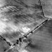 Oblique aerial view of East Reston Mill centred on the cropmarks of a settlement, taken from the WSW.