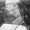 Oblique aerial view centred on the cropmarks of the trackway and linear cropmarks with the remains of the linear earthwork adjacent, taken from the ENE.