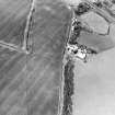 Oblique aerial view centred on the cropmarks of the settlement with the cropmarks of a settlement and field boundary adjacent, taken from the S.