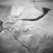 Oblique aerial view centred on the remains and cropmarks of the possible settlement, taken from the NE.