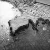 Oblique aerial view centred on the remains of the artillery fortification, taken from  the N.