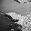 Oblique aerial view centred on the remains of the artillery fortification, taken from  the NW.