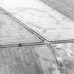 Oblique aerial view centred on the cropmarks of the barrow and ring-ditch, taken from the SW.