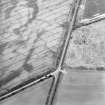 Oblique aerial view centred on the cropmarks of the barrow and frost wedges, taken from the W.