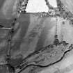 Oblique aerial view centred on the cropmarks of the barrow and unenclosed settlement, taken from the SW.