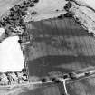 Oblique aerial view centred on the cropmarks of the barrow and unenclosed settlement, taken from the NW.