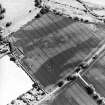 Oblique aerial view centred on the cropmarks of the barrow and unenclosed settlement, taken from the NNW.