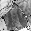 Oblique aerial view centred on the cropmarks of the barrow and unenclosed settlement, taken from the ENE.