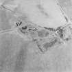 Oblique aerial view centred on the remains of the farmstead, taken from the SE.