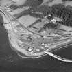 Aerial view of the lighthouse, the church and burial ground, Lochryan House, Glen Cottage military camp, Cairnryan military head quarters and Cairnryan military railway and ship yard. View taken from the SW.