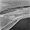 Beach Cottage, oblique aerial view, taken from the NW, showing linear cropmarks and cultivation remains, and the remains of Cairnryan Military Railway.