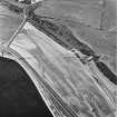 Beach Cottage, oblique aerial view, taken from the SW, showing linear cropmarks and cultivation remains, and the remains of Cairnryan Military Railway.