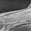 Beach Cottage, oblique aerial view, taken from the SE, showing linear cropmarks and cultivation remains, and the remains of Cairnryan Military Railway.