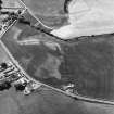 Garleffin, oblique aerial view, taken from the NE, centred on the cropmarks of a four poster stone-circle, ring-ditches, a barrow and pits. An area with a possible souterrain, enclosures and cropmarks is visible in the right half of the photograph.