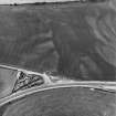 Ballantrae Bridge, oblique aerial view, taken from the NE, showing the cropmarks of field boundaries, a possible souterrain and round house, possible enclosures and an area with pits.