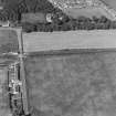 Oblique aerial photograph of Dunragit taken from the SSW, centred on a cropmark complex.
