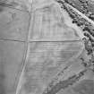 Oblique aerial view centred on the cropmarks of the Roman temporary camp with quarry pits adjacent, taken from the NNE.