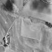 Oblique aerial photograph of Girvan Mains taken from the N, centred on the cropmarks of a fort.