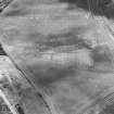 Oblique aerial view centred on the cropmarks of the pit-circle, pit-setting, possible enclosures, field boundary, linear cropmarks and pits, taken from the NNE.