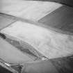 Oblique aerial view centred on the cropmarks of the fort, taken from the WSW.