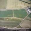 Oblique aerial view centred on the cropmarks of the fort with the farmsteading adjacent, taken from the NW.