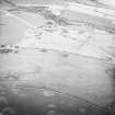 Oblique aerial view centred on the remains of rig, taken from the WSW.