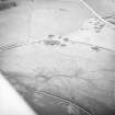 Oblique aerial view centred on the remains of rig, taken from the SW.