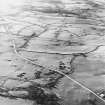 Oblique aerial view centred on the remains of rig, taken from the ENE.