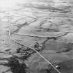 Oblique aerial view centred on the remains of rig, taken from the ENE.