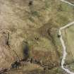 Oblique aerial view centred on the remains of the farmstead, field-system, rig and small cairns, taken from the WNW.