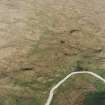 Oblique aerial view centred on the remains of the field-system and small cairns, taken from the SW.