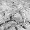 Oblique aerial view centred on the remains of the farmstead, field-system, rig and small cairns, taken from the WNW.