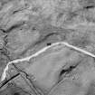 Oblique aerial view centred on the remains of the farmstead, field-system, rig and small cairns, taken from the SW.