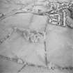 Oblique aerial view centred on the remains of the fort and rig with village adjacent, taken from the WSW.