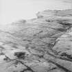 Oblique aerial view centred on the remains of the field-system, taken from the ENE.