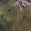 Oblique aerial view centred on the remains of the possible Roman fortlet, taken from the WNW.