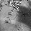 Oblique aerial view centred on the remains of the possible Roman fortlet, taken from the NW.