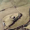 Oblique aerial view centred on the remains of the motte-and-bailey castle, taken from the ESE.