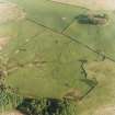 Oblique aerial view centred on the remains of the farmstead, field-system and rig with possible homestead, fort and rig adjacent, taken from the NNW.