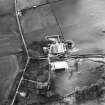 Oblique aerial view centred on the tower house with rig adjacent, taken from the ENE.
