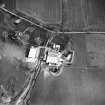 Oblique aerial view centred on the tower house with rig adjacent, taken from the NW.