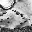 Drumlanrig, oblique aerial view, taken from the WNW, centred on the cropmarks of a Roman Fort. A Roman Temporary Camp, linear cropmarks and a pit-alignment are visible in the top right-hand corner of the photograph.