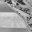 Oblique aerial view centred on the cropmarks of the cursus, taken from the ESE.