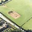 Oblique aerial view of Holywood centred on the excavation of a cursus and ring-ditch, taken from the NNE.